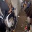 Two clips show how meals, trays, and plastic cutlery litter the aisles on the flight from Luanda to Lisbon on March 23