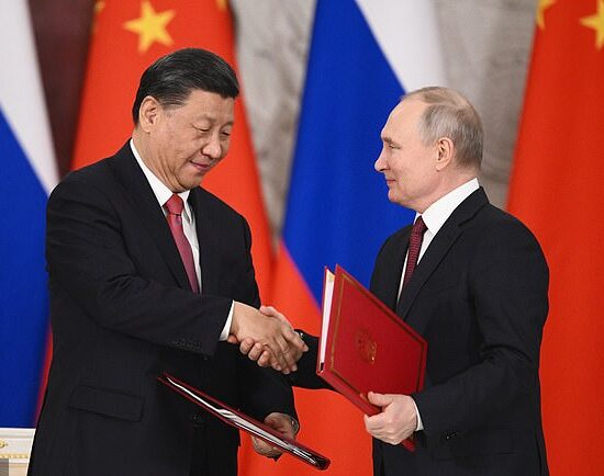 Speaking after talks with Chinese President Xi Jinping (pictured together), Putin said the move heralds the West switching to supplying Kyiv with weapons containing nuclear components, adding that Moscow will 'respond' if the UK goes ahead with its delivery of 14 next-generation battle tanks