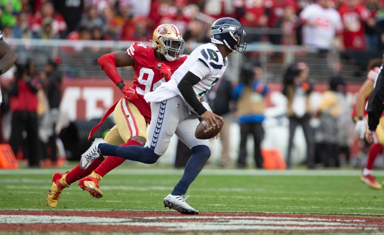 SANTA CLARA, CA - JANUARY 14: Geno Smith #7 of the Seattle Seahawks looks for a receiver against the San Francisco 49ers during the NFC Wild Card playoff game at Levi's Stadium on January 14, 2023 in Santa Clara, California. The 49ers defeated the Seahawks 41-23. (Photo by Michael Zagaris/San Francisco 49ers/Getty Images)