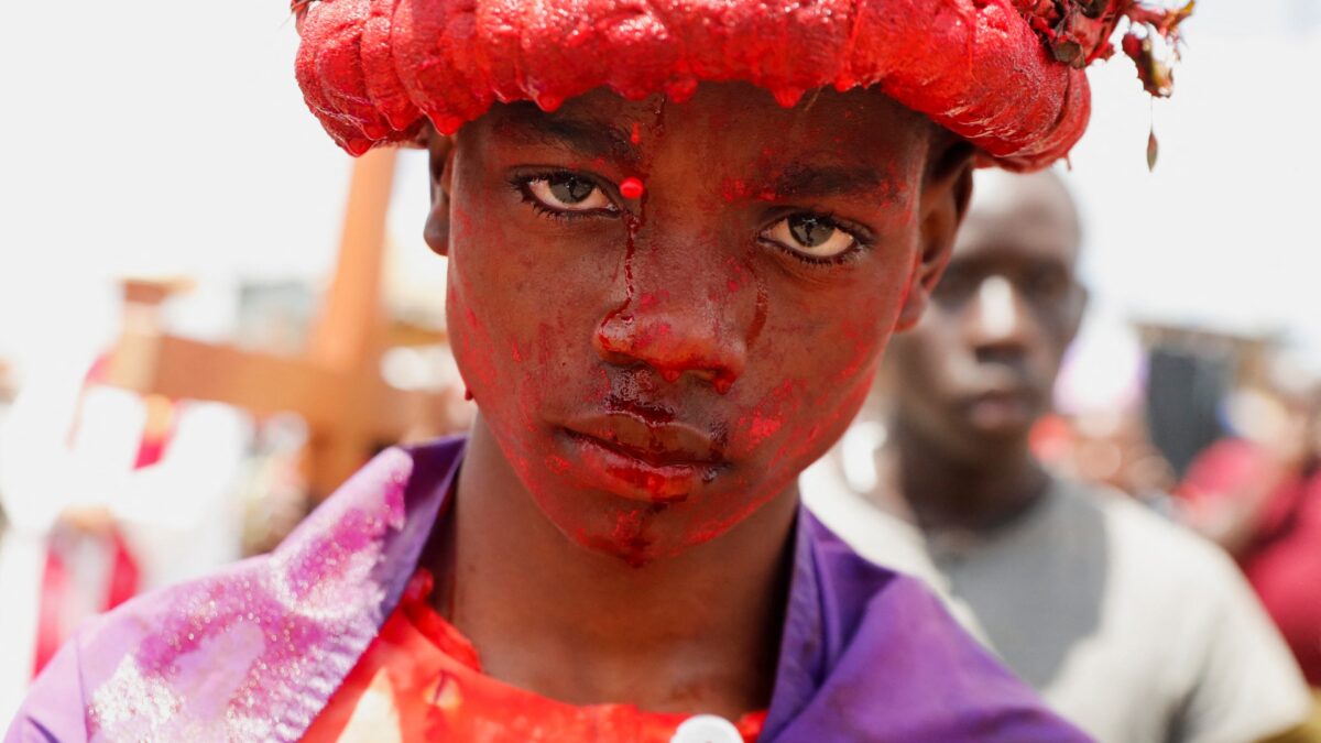 Christians wearing real crowns of thorns drip with blood as they recreate the crucifixion of Jesus in Easter rituals