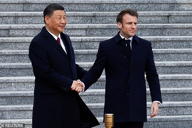 China's ambassador to the European Union has attempted to distance Beijing from Moscow after a strengthening of ties between the nuclear-armed superowers, as French president Emmanuel Macron arrived for a meeting with Xi Jinping (pictured together on Thursday)