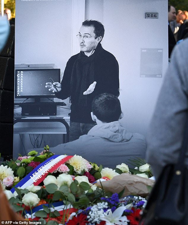 A photograph depicting French history and geography teacher Samuel Paty is seen at his tribute ceremony in Eragny-sur-Oise, northwestern Paris