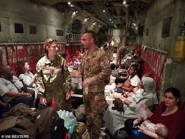 Italian citizens are boarded on an Italian Air Force C130 aircraft during their evacuation from Khartoum, Sudan, on Monday