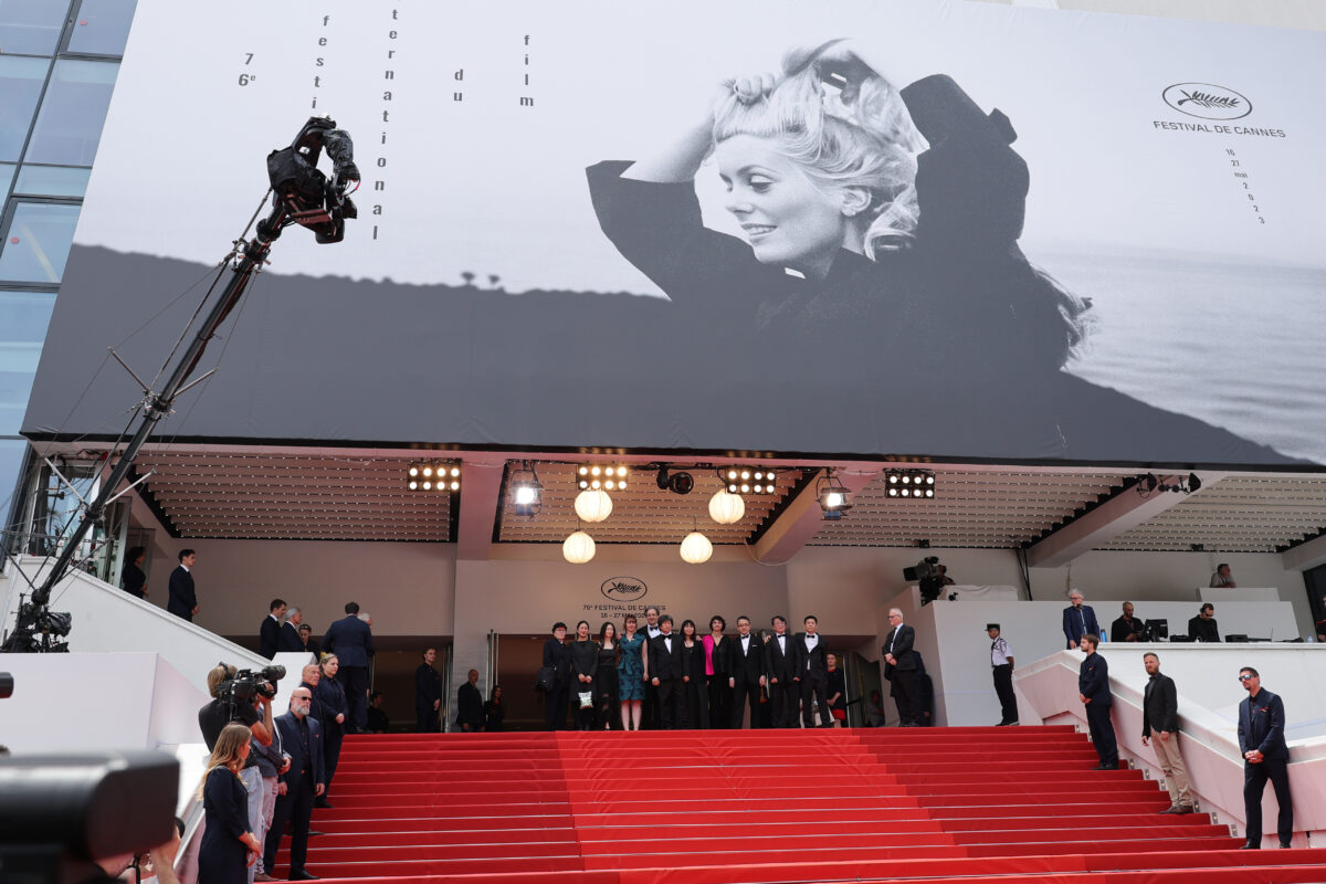 CANNES, FRANCE - MAY 18: Director Wang Bing (4th L) and production team attend the "Jeunesse (Le Printemps) (Youth Spring)" red carpet during the 76th annual Cannes film festival at Palais des Festivals on May 18, 2023 in Cannes, France. (Photo by Mike Coppola/Getty Images)