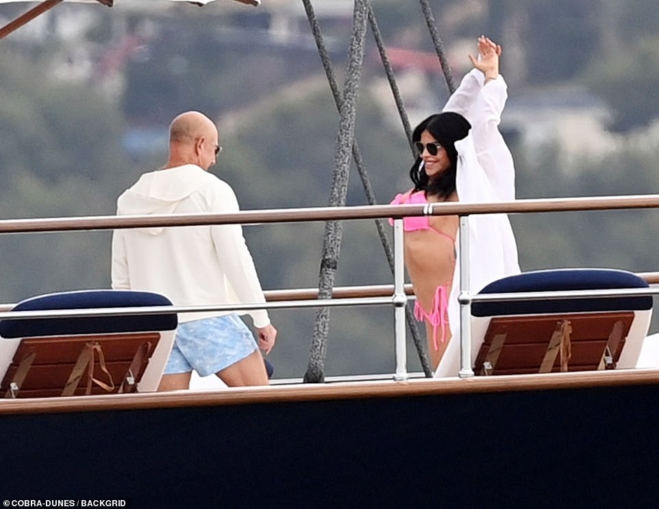 Bezos gazes at his girlfriend Lauren Sanchez as she stretches in her pink bikini on his superyacht off the coast of Spain