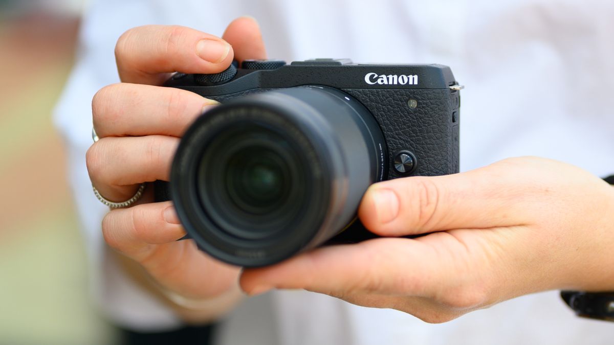 Two hands holding the Canon EOS M6 Mark II