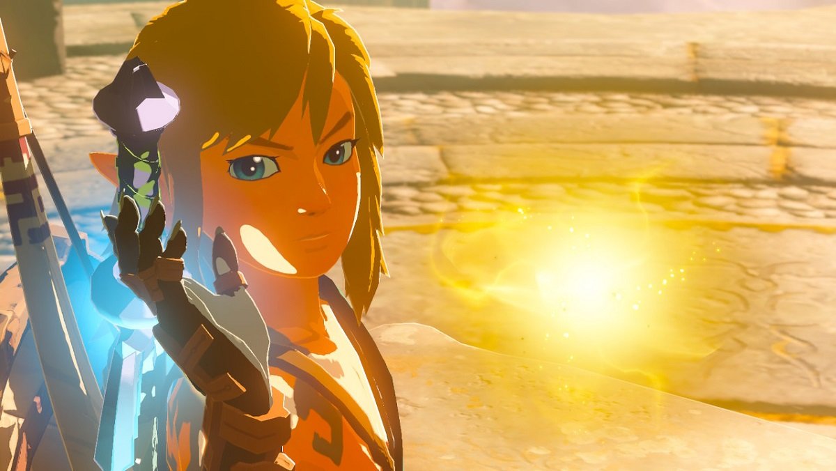 Link holding up a glowing thing in front of a gorgeous, sun-kissed beach in The Legend of Zelda: Tears of the Kingdom.
