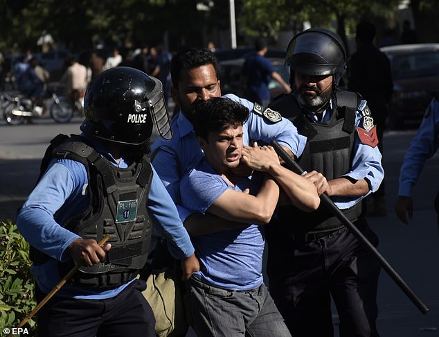 Police officers detain a supporter of Pakistan's former Prime Minister Imran Khan as they protest against his arrest, in Islamabad, Pakistan, on May 9, 2023