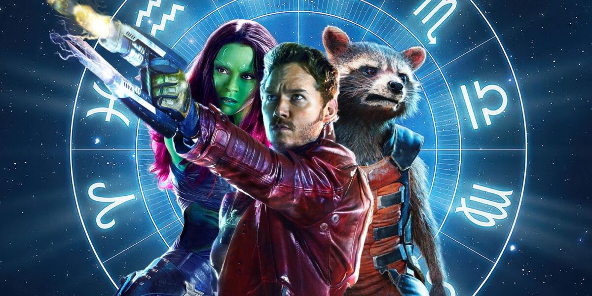 From L to R: Green-skinned alien woman, human male, and anthropormorphic racoon against a blue background interlaid with a wheel featuring the signs of the zodiac
