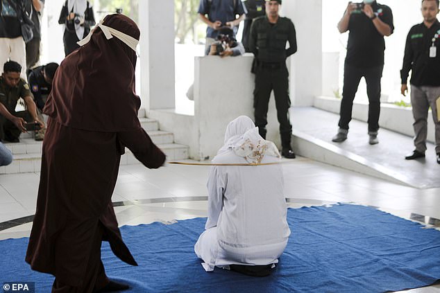 An Acehnese woman receives a caning punishment of 21 lashes for breaking the Sharia law in Banda Aceh, Indonesia, on June 7, 2023