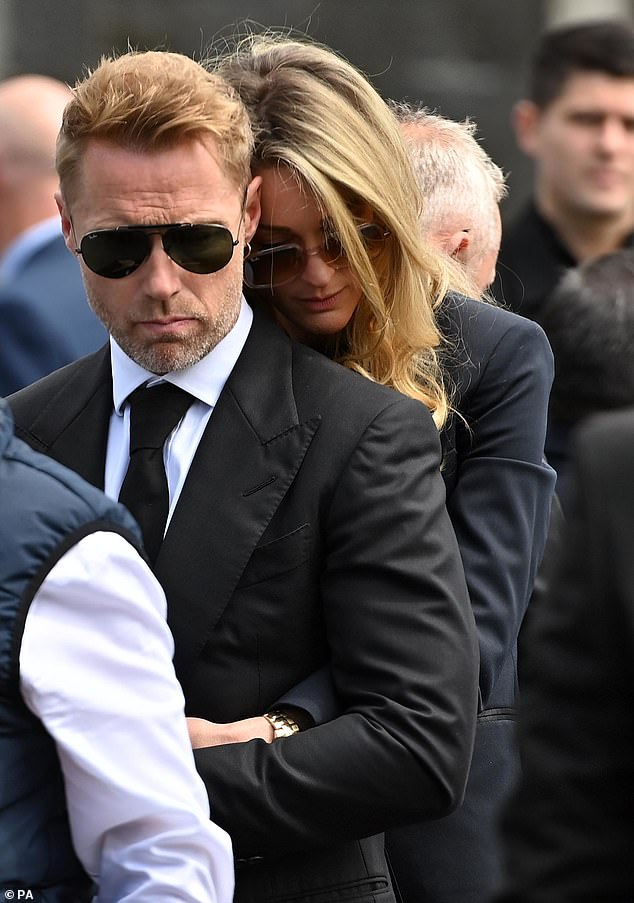 Grieving Ronan Keating was consoled by his wife Storm outside St Patrick's Church in Louisburgh, Co Mayo, after the funeral of his brother Ciaran