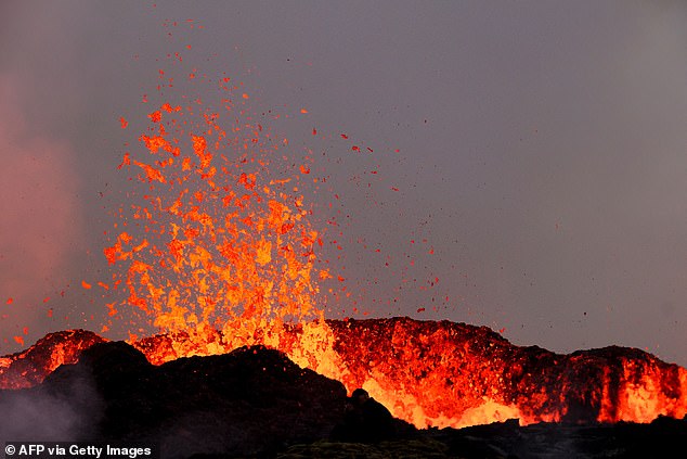 A volcanic eruption that has seen lava snaking its way down the side of a mountain in Iceland - just 20 miles from the country's main airport - has today prompted warnings that it is spewing out 'life-threatening toxic gas pollution'.