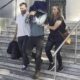 Josh James Menkens (centre) was pictured today being taken from a courthouse in the city of Leiria, an hour's drive away from the commune after being quizzed by a judge investigating the case