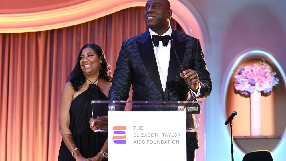 BEVERLY HILLS, CALIFORNIA - SEPTEMBER 21: (L-R) Cookie Johnson and Magic Johnson speak onstage during the Elizabeth Taylor Ball to End AIDS at The Beverly Hills Hotel on September 21, 2023 in Beverly Hills, California. (Photo by Jon Kopaloff/Getty Images for The Elizabeth Taylor AIDS Foundation)