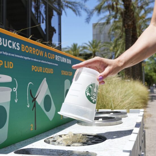 A reusable cup is returned to a 'borrow a cup' return bin in Arizona on June 7, 2023. (Ross D. Franklin / AP)