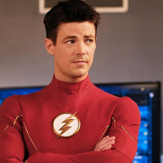 Grant Gustin wearing The Flash uniform without mask