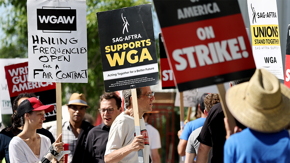 LOS ANGELES, CALIFORNIA - JULY 13: A sign reads 'SAG-AFTRA Supports WGA' as SAG-AFTRA members walk the picket line in solidarity with striking WGA (Writers Guild of America) workers outside Netflix offices on July 13, 2023 in Los Angeles, California. Members of SAG-AFTRA, Hollywood’s largest union which represents actors and other media professionals, will likely go on strike after a midnight deadline over contract negotiations with studios expired. The strike could shut down Hollywood productions completely with writers in the third month of their strike against Hollywood studios. (Photo by Mario Tama/Getty Images)