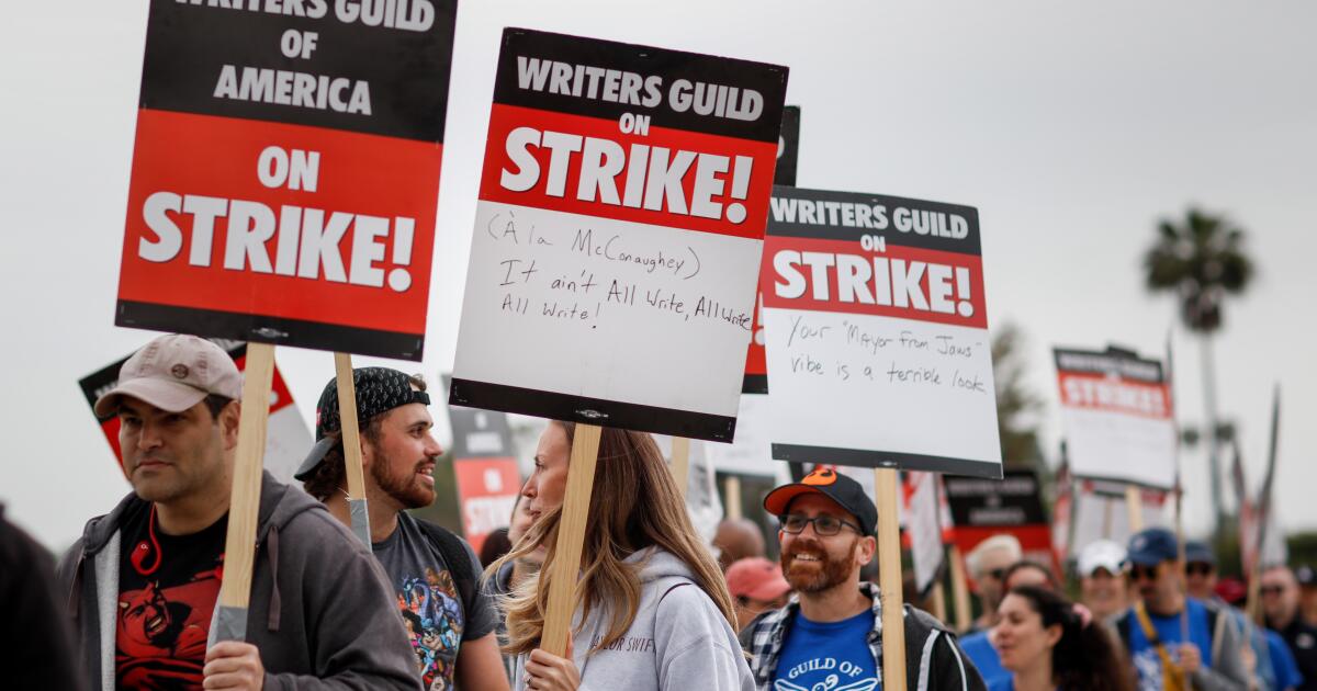 WGA, studios bargain for third straight day. Writers hit picket lines in droves