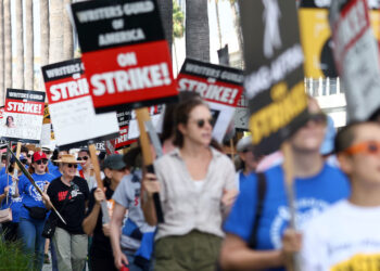 LOS ANGELES, CALIFORNIA - SEPTEMBER 22: Striking WGA (Writers Guild of America) members picket with striking SAG-AFTRA members outside Netflix studios on September 22, 2023 in Los Angeles, California. The Writers Guild of America and Alliance of Motion Picture and Television Producers (AMPTP) are reportedly meeting for a third straight day today in a new round of contract talks in the nearly five-months long writers strike.  (Photo by Mario Tama/Getty Images)