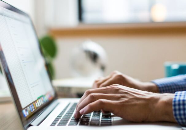 A person typing on a laptop