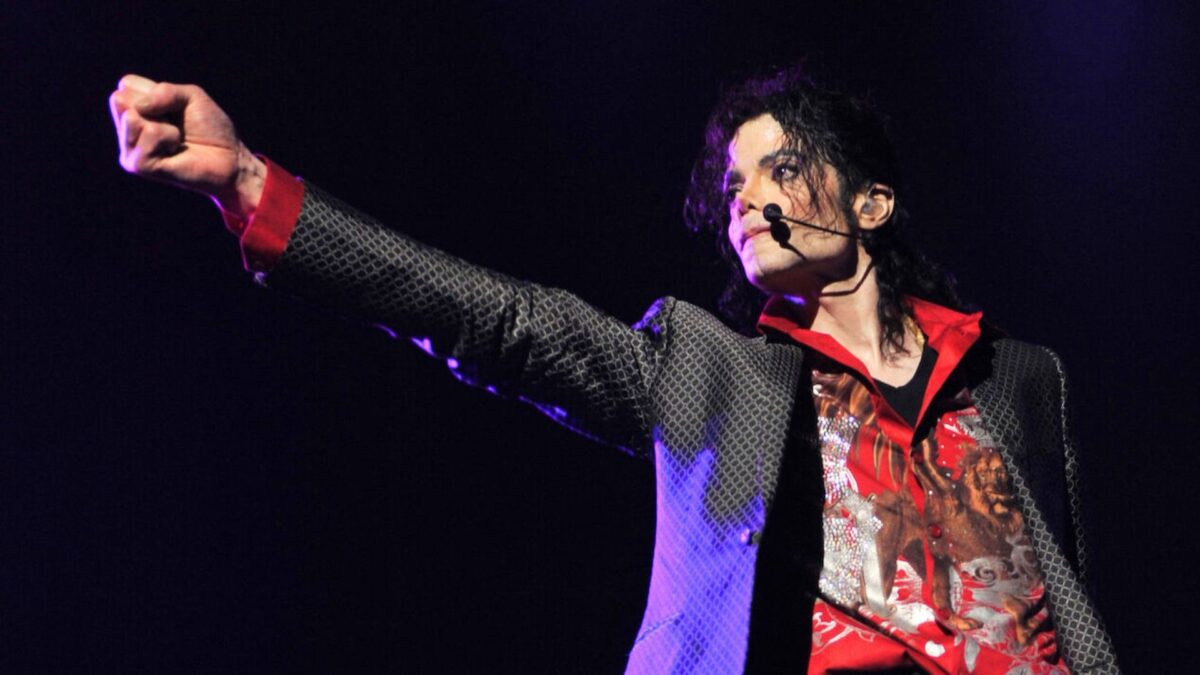 Michael Jackson punches his fist out while performing on stage