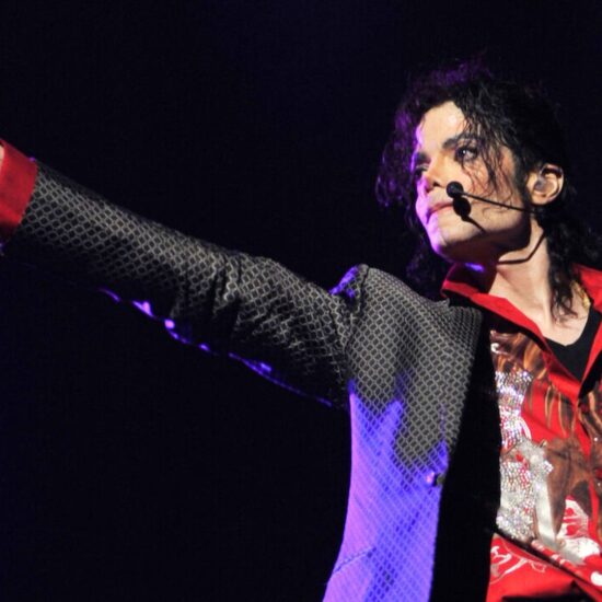 Michael Jackson punches his fist out while performing on stage