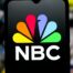 In this photo illustration, the NBC (National Broadcasting Company) logo is seen displayed on a smartphone screen.