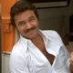 Burt Reynolds in all white, smiling in The Cannonball Run