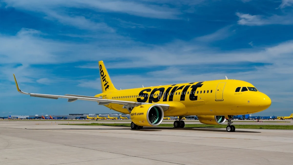 A yellow Spirit airplane on the ground at an airport