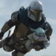 Grogu and the Mandalorian flying through the air
