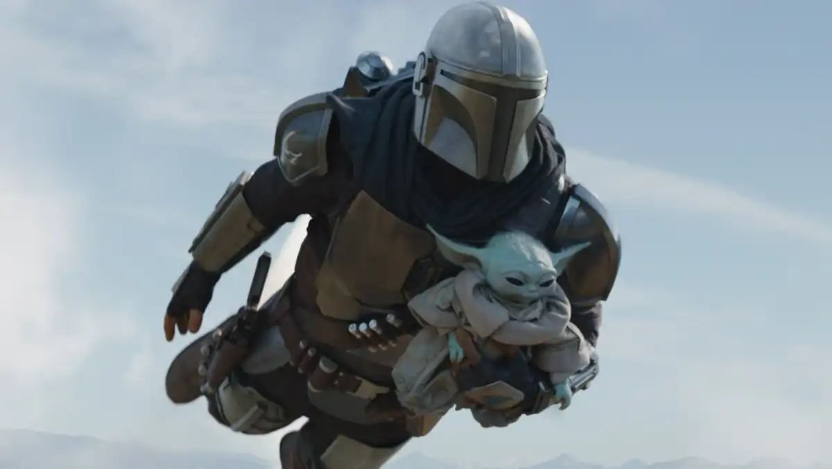 Grogu and the Mandalorian flying through the air