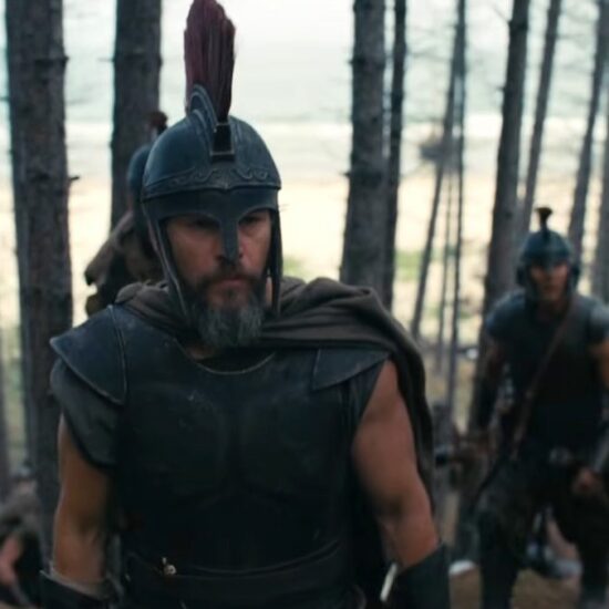 Matt Damon in a large plumed hat in the woods with soldiers in The Odyssey