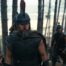 Matt Damon in a large plumed hat in the woods with soldiers in The Odyssey