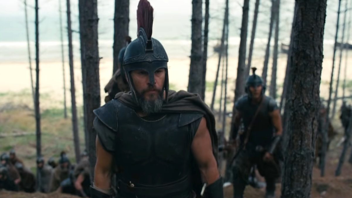 Matt Damon in a large plumed hat in the woods with soldiers in The Odyssey