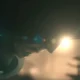 Dr Doom kneeling with his mask and hood on with a setting sun behind him in Avengers: Doomsday