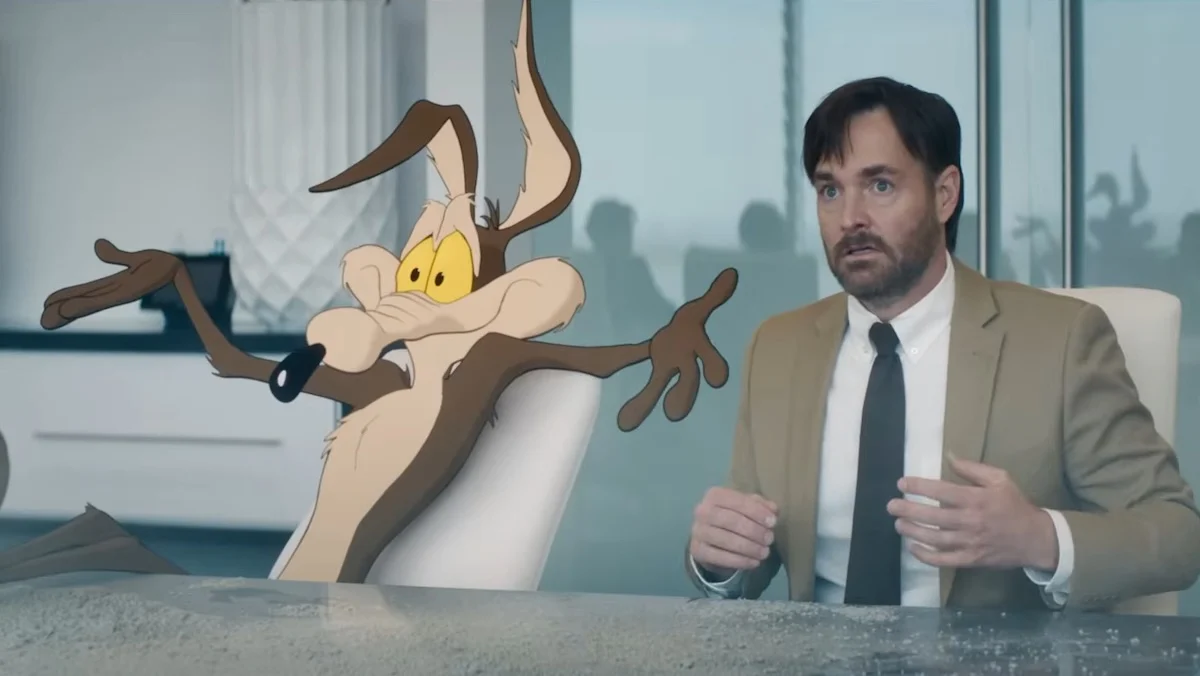 Wile E. Coyote with his arms stretched out as Will Forte looks nervous in Coyote vs. ACME