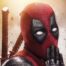 Deadpool with his hand over his mouth
