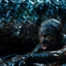 A still from Beware Boi&uacute;na, showing a terrified doctor covered in mud with the enormous snake behind her.