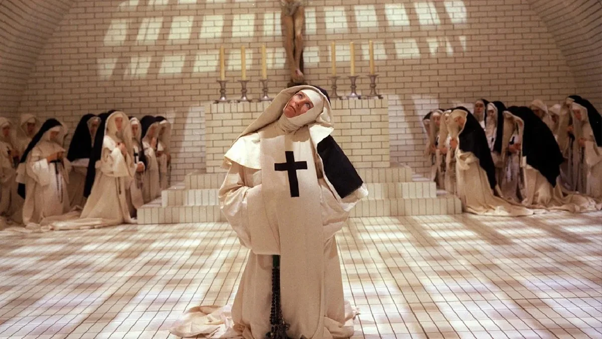 Sister Jeanne (Vanessa Redgrave) kneels amid other nuns and a crucifix in Ken Russell