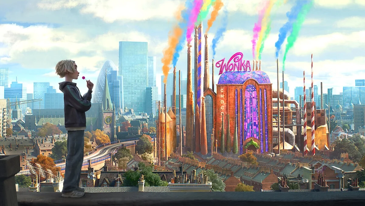 A kid in the foreground eats a lollipop with the colorful Wonka factory with colorful smokestacks dominates a London cityscape in Charlie Vs. The Chocolate Factory