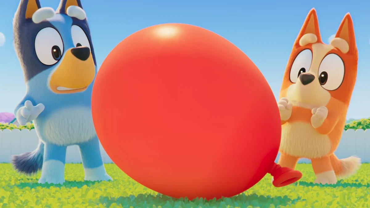 A still from the Bluey Movie teaser showing Bluey and Bingo playing with a balloon.