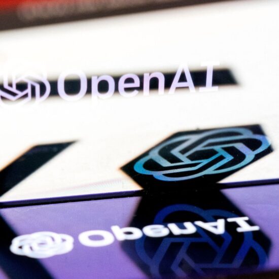 OpenAI logo on smartphone, reflected on main screen