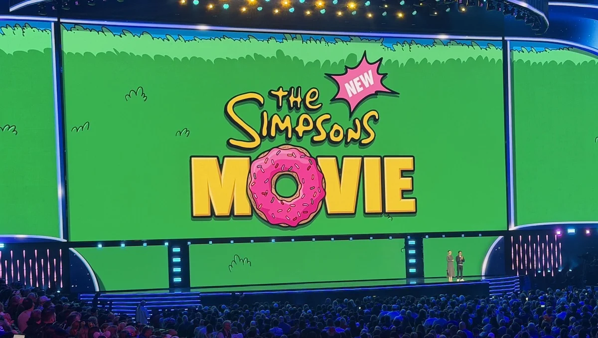 Green and yellow title card for The New Simpsons Movie with release date