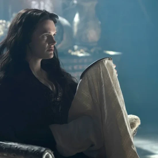 Gayle Rankin as Alys River near a fireplace on House of the Dragon