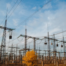 Electrical pylons and high voltage power lines are behind a barbed wire fence. critical infrastructure