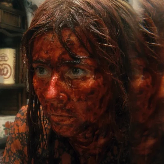 A blood-soaked Linda Cardellina seen with a double reflection on Crystal Lake