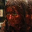 A blood-soaked Linda Cardellina seen with a double reflection on Crystal Lake