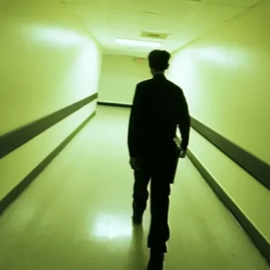 Paul Syre walks down a terrifying hallway in the found-footage horror movie Infirmary.