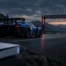 Racing car approaching an empty finish line beside an unbranded game console, symbolizing a delayed PlayStation launch.