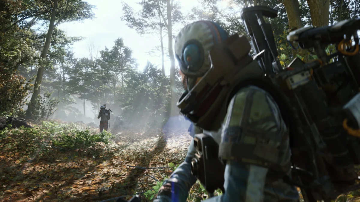 Over-the-shoulder view of a character in a futuristic suit in a wooded environment from Arc Raiders.